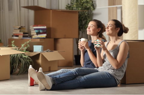 Relaxing in their new rental apartment amidst moving boxes. Seamless property search and secure contracts for rent in Barcelona.